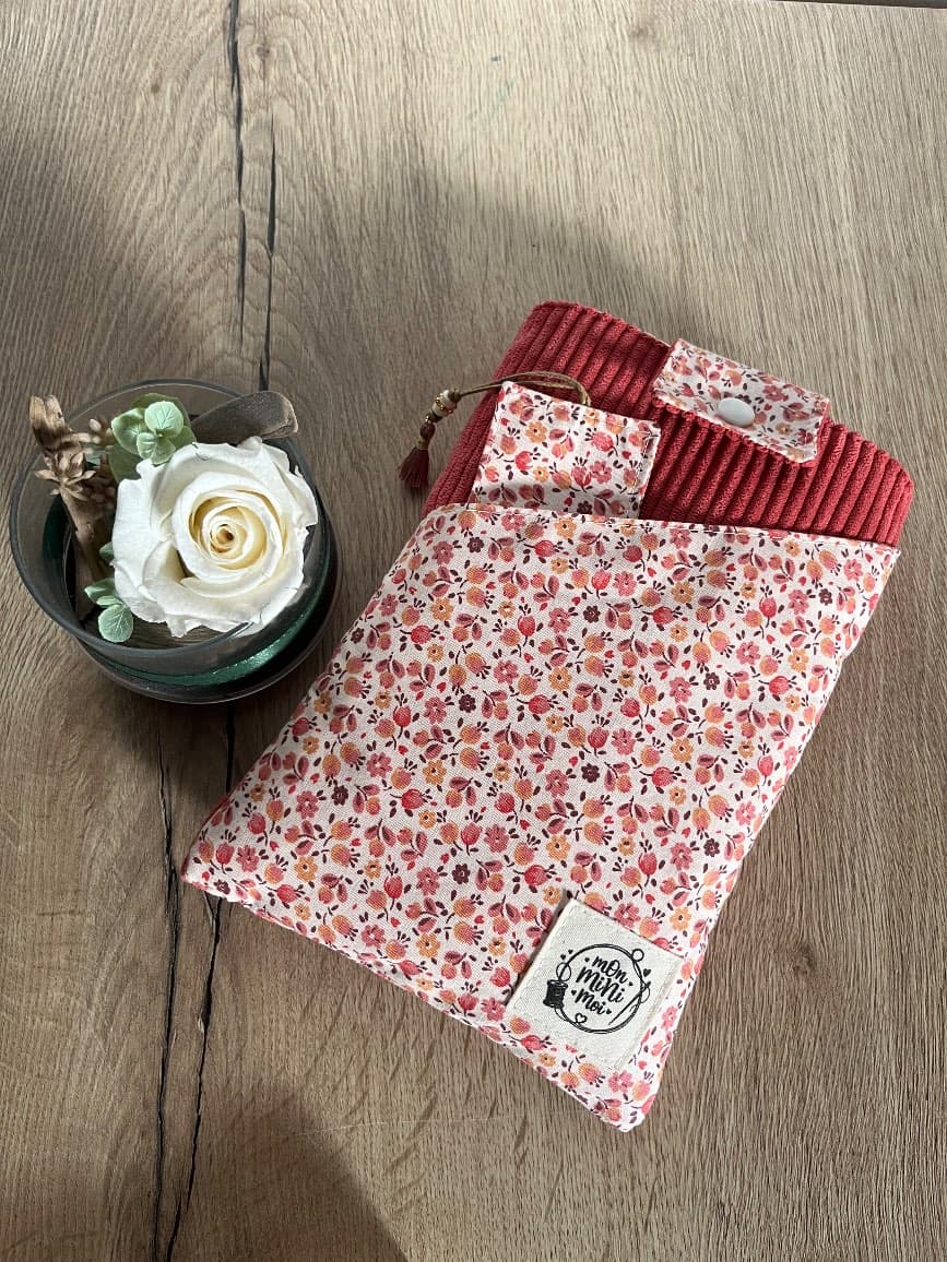 Pochette à livre fermée en velours côtelé rose et tissu fleuri avec marque-page inséré dans la poche